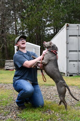 Belle, the longest dog resident at the Madison Oglethorpe Animal Shelter, jumps on executive director Juli Huth. Recently hired, Huth has goals "to see (the shelter's) length of stay go down." (Photo/Jennifer Xia)
