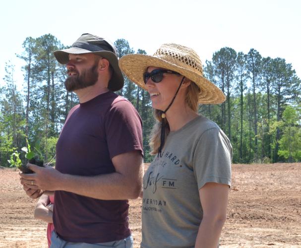 Craig and Chelsie Cheeseborough presented three coneflower sprouts at the Holy Ground Community Garden grand opening. Cheeseborough said the three sprouts represent “the Father, the Son and the Holy Ghost.” (Photo/Adriana Cascio)