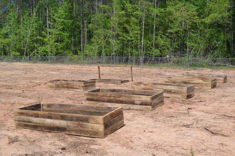 Raised garden beds sit on the right side of the Holy Ground Community Garden. Dwight Howard, founder of the garden, said he wanted the garden to be accessible for elders and those unable to get low to the ground. (Photo/Adriana Cascio)