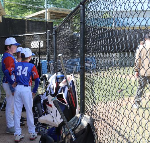 Members of the Major League home team stand in the dugout and cheer for teammates during the combined team game on April 12 at Bryan Park. All of the players live in Oglethorpe County and most have played with each other from previous seasons, Michael White said. (Photo/Anna Izquierdo)