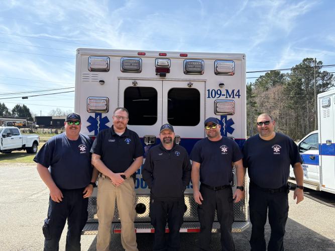 EMS Department team, including, Kelly Huff (left), Josh Robinson, Jeffrey Clark, Roy Allen, Dennis Weaver (right), work with other departments to keep the city afloat. “We all just kind of come and work together,” Robinson said, when discussing how the departments within the county interact. (Photo/Emery Pikel)