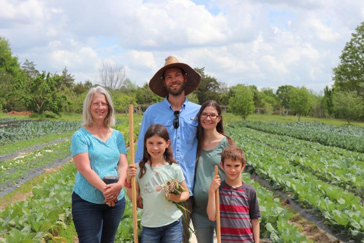Susan Shaw (top left), her daughter Jennifer Johns (top right), and son-in-law Josh Johns (center) pose with grandchildren Madelyn and Levi Johns (bottom left and right) for a photo at Hickory Hill Farms. (Photo/ Lilly Stone)