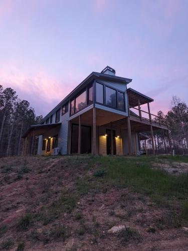 Anastasia Davis’s new home is in Maxeys on Sunday, March 30. The suspended bedroom and deck with joint fireplaces hang above the drive-through garage and barn. (Photo/Anastasia Davis)