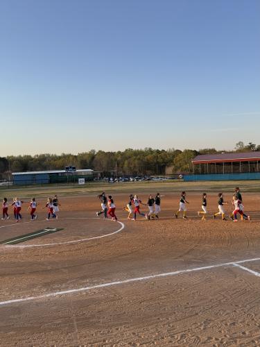 Both teams run on the field to offer high fives to teammates and opponents last Thursday following the 8-0 Oglethorpe County loss. Kitchens said she is hopeful her team will take their fundamental skills to be ready for the all-stars league at the end of the season. (Photo/Anna Izquierdo)