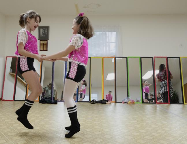 From left: dancers Brylee Pavlosky and Ava Grace Gay jump in excitement after trying on their costumes for an upcoming performance with their tap and jazz combo class at the Lena Wise Community Center in Crawford, Ga on April 7, 2025. The dancers are a part of Jessica's School of Dance, a complete dance program for young girls of all ages led by instructor Jessica Palmer. (Photo / Lux Corrona)