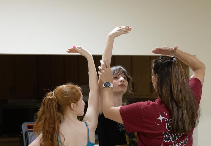 Dance instructor Jessica Palmer works with dancers Marlee Waldrowp (left) and Grace Foland (right) as they practice a dance routine paired with a song titled "Interlude: Dawn" during their ballet II/III class led by Palmer at the Lena Wise Community Center on April 7, 2025. Palmer is the owner and instructor of Jessica's School of Dance, a complete dance program for young girls of all ages. (Photo / Lux Corrona)