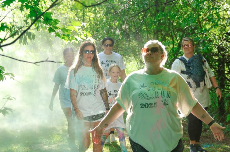 A group of runners walk through a patch of sunlight along the Oglethorpe County High School Color Run course at the Oglethorpe County High School in Oglethorpe County, Georgia, on Saturday, April 26, 2025. The Color Run itself was planned and run almost entirely by the members of the Oglethorpe County High School National Honor Society, alongside help from their teacher and NHS advisor Jennifer Yauck. “They sell the registrations at lunch, they come in here on Friday afternoon and get all the color ready an