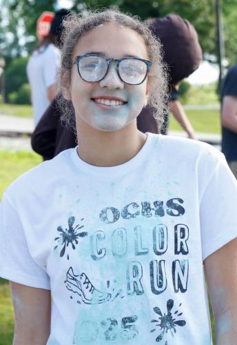 Abby Hormeku, a sophomore student at Oglethorpe County High School, poses for a portrait at the finish line of the Oglethorpe County High School Color Run course at the Oglethorpe County High School in Oglethorpe County, Georgia, on Saturday, April 26, 2025. Hormequ was among the students responsible for choosing The CAYA House as the OCHS Color Run’s fundraising charity, as each year the members of the National Honor Society vote on which local nonprofit will be donated the proceeds of the event. (Photo/Fe