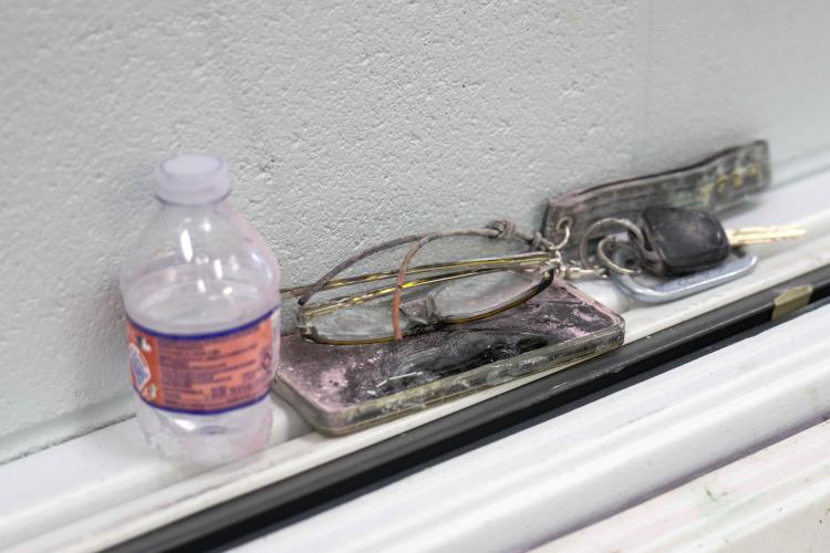 A pair of glasses, a phone, and a set of car keys, all covered in chalk powder, sit on a small outcropping of a wall within the Oglethorpe County High School gym in Oglethorpe County, Georgia, after the Oglethorpe County High School Color Run on Saturday, April 26, 2025. (Photo/Felix Scheyer)