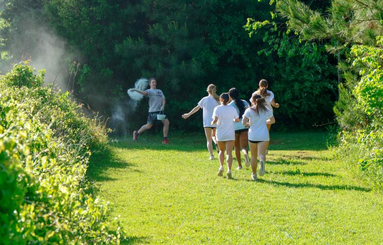 Jake Huff, a sophomore student at Oglethorpe County High School, prepares to throws chalk at runners as they run along the Oglethorpe County High School Color Run in Oglethorpe County, Georgia, on Saturday, April 26, 2025. Though the chalk kept blowing back into his face, Huff was excited to be able to participate in the Color Run while raising funds for The CAYA House. (Photo/Felix Scheyer)