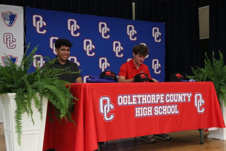 Andy Alvarez (left) and Bryce Frankel sign with the inaugural apprenticeship program between OCHS and the Mechanical Trades Institute at the school on May 15. Alvarez and Frankel will begin work with contractor Batchelor &amp; Kimball in September. (Photo/Anna Izquierdo)