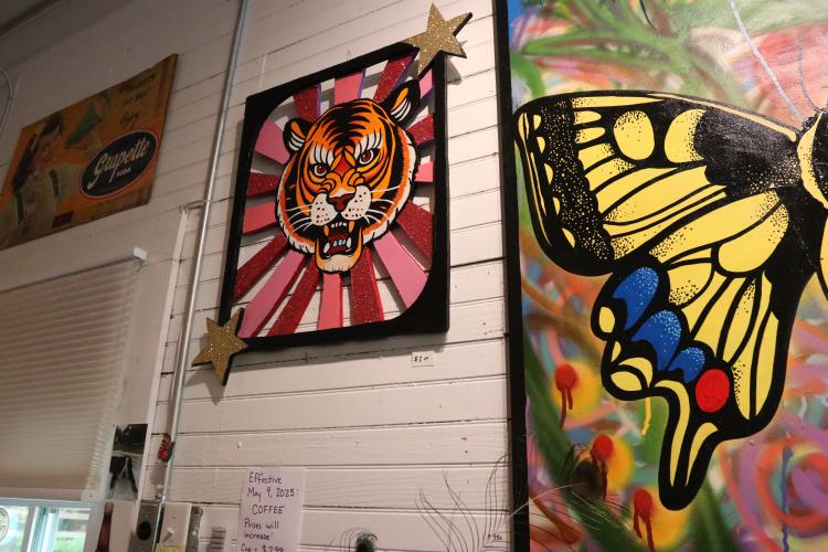 A tiger created from wooden cut outs and decorated with glitter hangs inside Rowdy Rooster. Mustard said this is her “favorite” piece because she enjoyed making the wooden pieces in multiple layers, and using glitter “makes (her) really happy.” (Photo/Anna Izquierdo)