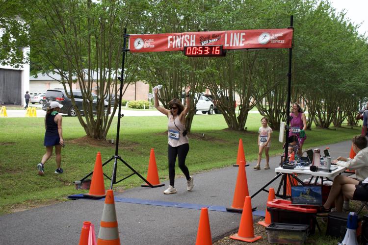 Runners pass the finish line in the Maxeys Model Mile 5K on Saturday, May 17. (Photo/Emma Greene)