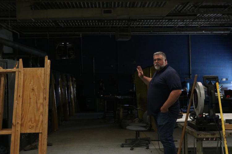 OCHS teacher Travis Sertich stands in the welding facility under renovation. Bryce Frankel and Andy Alvarez will attend night classes in the facility starting in September. (Photo/Anna Izquierdo)