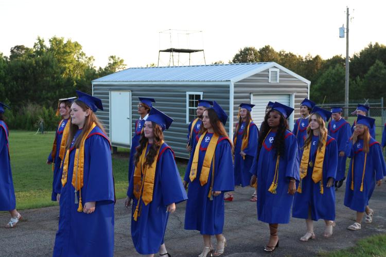 Honorarian Emily Carter and salutatorian Alie Duffell line up at Patriot Stadium last Friday before taking their seats on the field for graduation. Duffell told her fellow graduates that it felt “surreal” to stand in front of the crowd during graduation. (Photo/Anna Izquierdo)