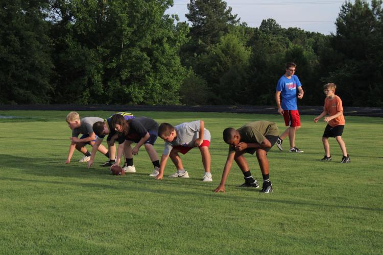 Student coach Riley Thompson watches as campers get in formation for a game of no-contact 7v7 football. Other student coaches at the camp included Keyvon Gresham, Hayden Williams, Ronnie McNew, William Deaton, Clint Graham and Jackson Tatum. (Photo/Elizabeth Kim)