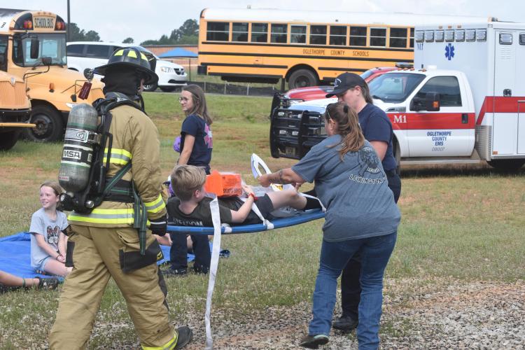 Oglethorpe County's Emergency Management Agency hosted a mass casualty exercise on Saturday. First responders helped volunteer students and a bus driver from a school bus that was flipped for the purpose of the exercise. (Photo/Emma Greene)