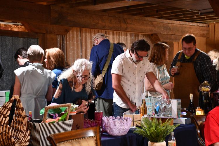 Guests of the Madison Oglethorpe Animal Shelter's 10th annual Bark &amp; Wine bid on donated prizes during the silent auction at the Historic Smithonia Farm. (Photo/Jennifer Xia)
