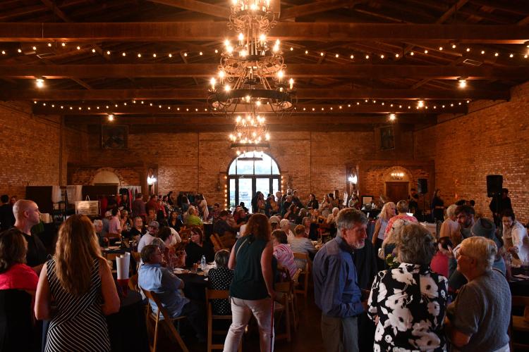 Guests participate at the live auction at the Madison Oglethorpe Animal Shelter’s 10th annual Bark &amp; Wine fundraiser at Historic Smithonia Farm on Saturday. Tickets and branded items were up for bid in the auctions. (Photo/Jennifer Xia)
