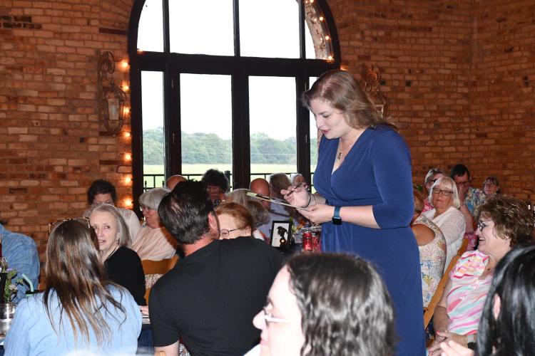 Madison Oglethorpe Animal Shelter board member and Bark &amp; Wine coordinator Sherrie Hines registers a winning bidder’s donation at the fundraiser’s live auction. The event raised $25,000 for the shelter. (Photo/Jennifer Xia)