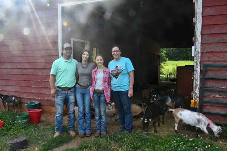 The Gabriel family poses in front of their dairy goat barn in Colbert. (Photo/Jennifer Xia)