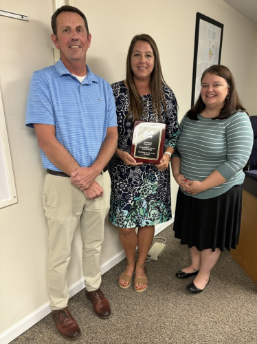 OCHS principal Bill Sampson (from left), healthcare sciences teacher Erin Bunch and Board of Education chair Becky Soto pose for a photo last September following Bunch's recognition as Teacher of the Year. Bunch said it was an honor to be selected by her peers to represent the county as System Teacher of the Year. (Submitted Photo)