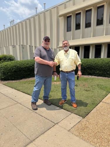 Danny Gorman (right) shakes hands with Jerry Gin outside of Conwed Plastics in Athens. An old friend and coworker of Gorman’s, Gin and other retirees returned to Conwed to congratulate him on his retirement. (Submitted Photo)