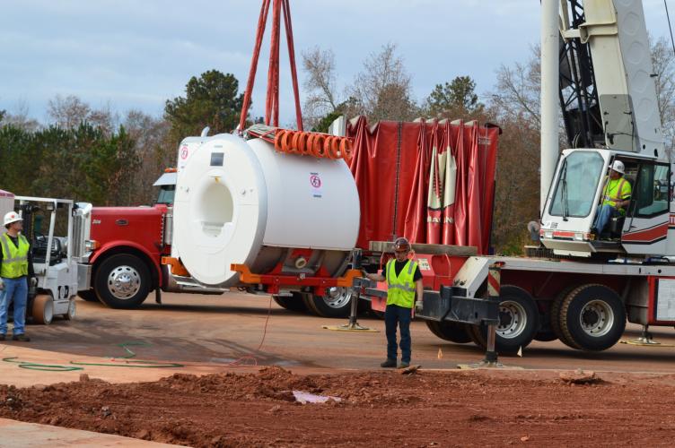 Employees from Atlanta-based architecture firm Perkins &amp; Will help to unload an MRI machine during construction and design of the University of Georgia Veterinary Teaching Hospital, which opened in 2015. Susan Sharp said the process often came with “learning curves,” like determining the amount of space the machines needed. (Submitted Photo)