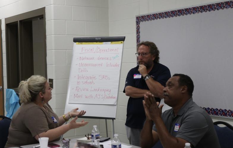 Marianne Camacho (from left), Paul Thiel and Frank Eberhart discuss fiscal and operational responsibilities during the Oglethorpe County School System’s strategic planning meeting on Tuesday at OCMS. (Photo/Anna Izquierdo)