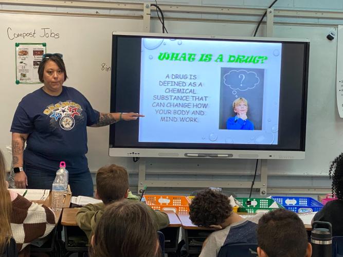 Former Sgt. Samantha Mathe gives the definition of “drug” to fifth-grade students on March 20, 2023 at Oglethorpe County Elementary School as part of the C.H.A.M.P.S. program. Now, Sgt. Jonathan Duke runs the program meant to educate young people and help address substance abuse issues in the county. (Photo/Brooke Stewart)