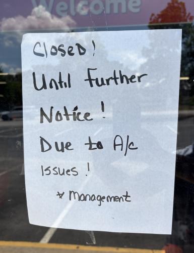 Signs posted on the door of the Family Dollar in Crawford state that air conditioning problems caused its temporary closure. It’s not known when it will reopen. (Photo/Andy Johnston)