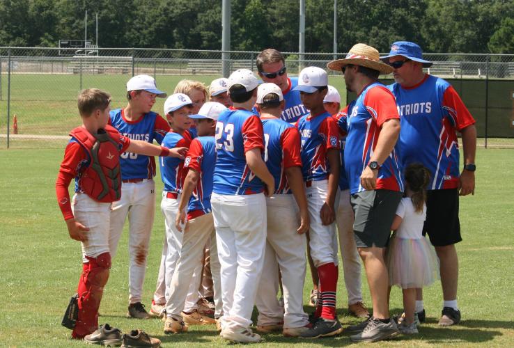 The Oglethorpe County Major league all-star team huddles around head coach Chuck Gabriel. The Patriots ended the season as district runner up against Franklin County on Friday. (Submitted Photo)