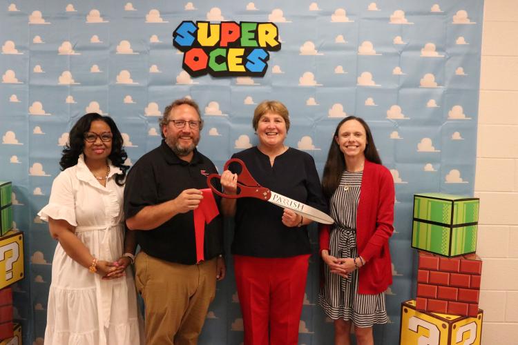 Assistant superintendent Kanya Cornish (from left), operations director Paul Thiel, superintendent Beverley Levine and OCES principal Katie Baldwin stand in OCES following the ribbon cutting on Sunday. (Photo/Anna Izquierdo)