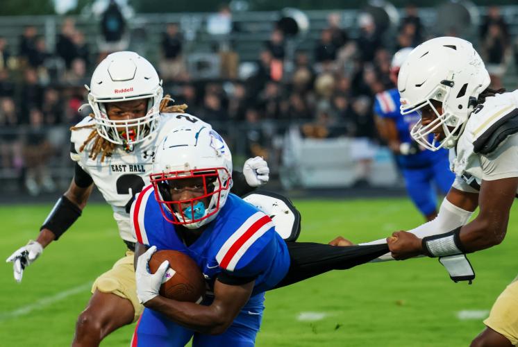 Paris Crowder on the field during the Saturday evening game getting his shirt tugged by the opposing team on Aug. 23, 2025. (Photo/McKenna Edwards)