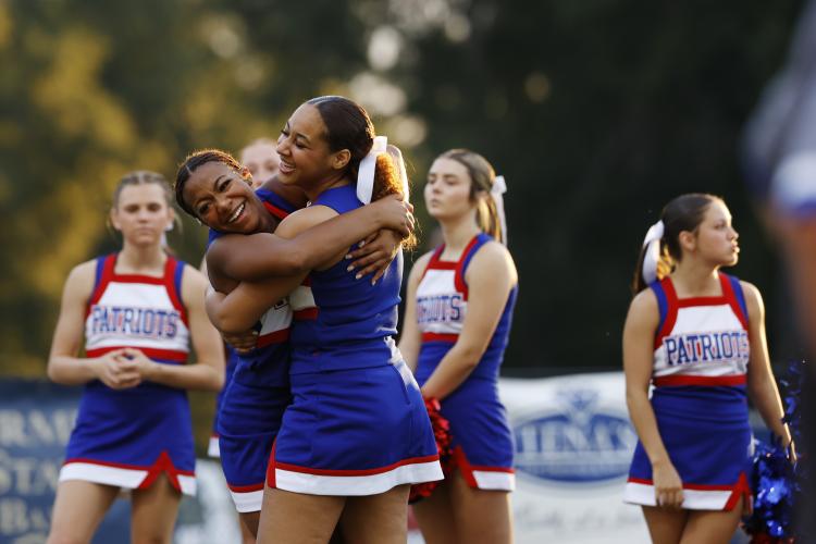 Oglethorpe County High School cheerleaders hug before the start of the football game against Washington Wilkes Comprehensive High School at Tiger Stadium in Washington, Georgia, on Aug. 29, 2025. (Photo/Susanna Johnson)