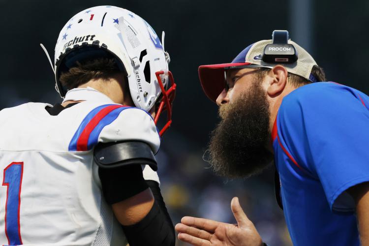 Oglethorpe County High School offensive coordinator Josh Austin gives direction to quarterback Caden Hartrum (1) during a game against Washington Wilkes Comprehensive High School at Tiger Stadium in Washington, Georgia, on Aug. 29, 2025. (Photo/Susanna Johnson)