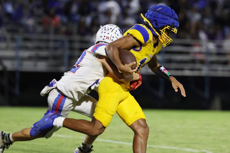 Oglethorpe County High School football player Clint Graham (22) tackles opponent Preston Stokes (16) during a game against Washington Wilkes Comprehensive High School at Tiger Stadium in Washington, Georgia, on Aug. 29, 2025. (Photo/Susanna Johnson)