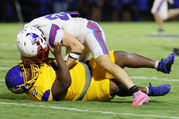Oglethorpe County High School football player Jayden Wilkinson (20) tackles opponent Tavorian Brittain (52) during a game against Washington Wilkes Comprehensive High School at Tiger Stadium in Washington, Georgia, on Aug. 29, 2025. (Photo/Susanna Johnson)