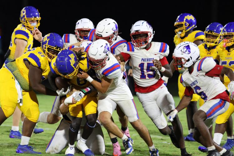 Oglethorpe County High School football players tackle opponent Dre'vioun Davis (8) during a game against Washington Wilkes Comprehensive High School at Tiger Stadium in Washington, Georgia, on Aug. 29, 2025. (Photo/Susanna Johnson)
