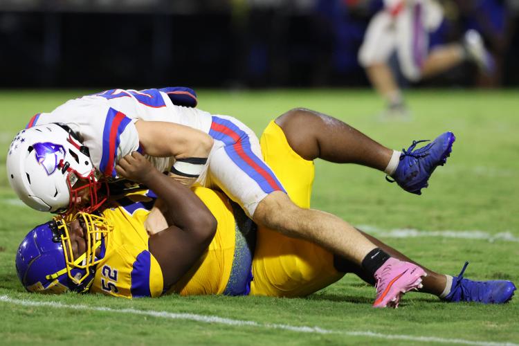 Oglethorpe County High School senior Keagan Moats (20) tackles Washington-Wilkes Comprehensive School senior Tavorian Brittain (52) during a game at Tiger Stadium in Washington, Georgia, on Aug. 29, 2025. (Photo/Katherine Davis)