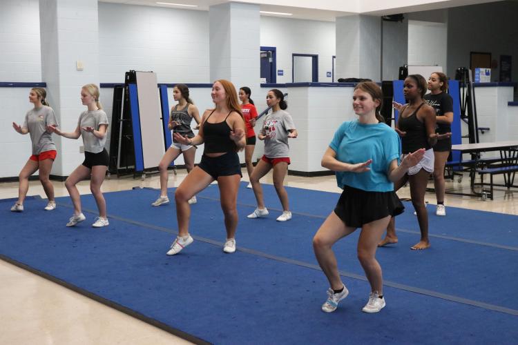Senior Kensie Brown (right) and junior Sara Myers work on their routines during  practice last week. Brown said she is excited for Friday night lights because it’s her “favorite part of the season.” (Photo/Anna Izquierdo)