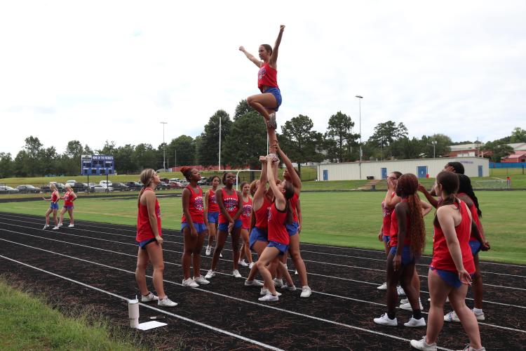 The OCHS cheerleaders work on their skills during practice last week. Coach Morgan Williams said 12 girls returned to the team, a majority of them juniors and seniors. (Photo/Anna Izquierdo)