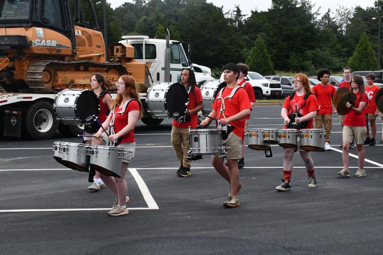 The Oglethorpe County High School marching band’s drumline marches out of the parking lot following its introduction performance at this year's Community Day. The band played the national anthem and the school’s fight song. (Photo/Jennifer Xia)