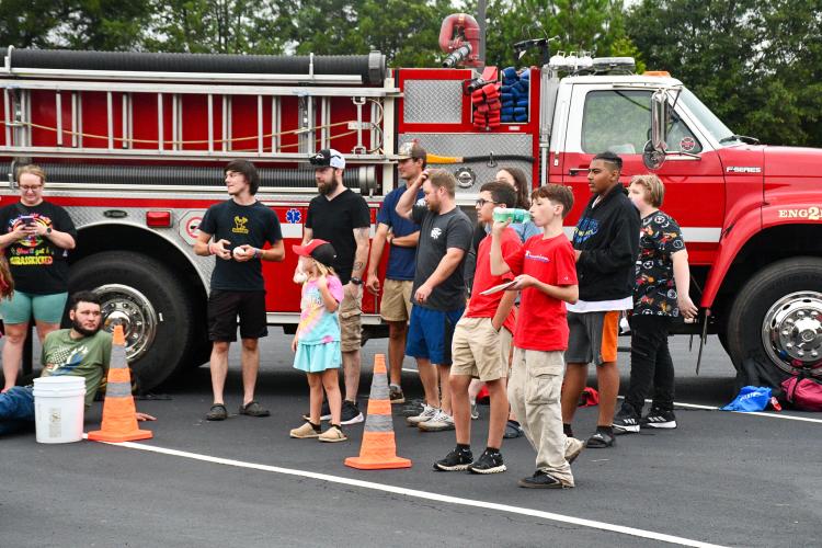Community members line up for a chance at the dunk tank at Community Day on Saturday. The annual event hosts community resources for parents and students as they head back to school. (Photo/Jennifer Xia)