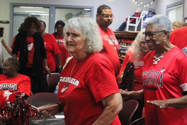 Oglethorpe County Senior Center members Eleanor Smith (left) and Alice Flint dance around in a "soul train." Smith said she likes visiting the center because it allows her to get out of the house and be social. (Hannah Freeman/The Oglethorpe Echo)