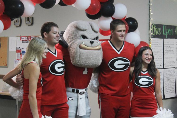 Hairy Dawg and the UGA cheer team pose for a photo at the Oglethorpe County Senior Center during their first tailgate party of the season on Friday. The event marked Hairy Dawg's first visit to the center. (Hannah Freeman/The Oglethorpe Echo)