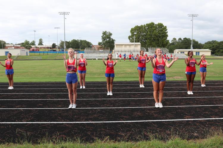 Juniors Lili Holt (left) and Sara Myers practice their routine at the track last week. Williams said 12 girls returned to the team, a majority of them juniors and seniors. (Photo/Anna Izquierdo)