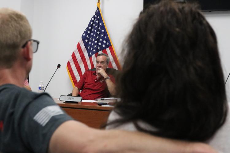 Council member Joel Kriner listens to public opinion during a hearing in Arnoldsville, Ga on Aug. 21, 2025. The council gathered for public input on the paving of Pine Grove Road. (Photo/Mia Fishman)