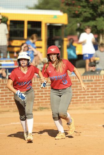 Oglethorpe County’s Emily Wisham (22) and Emilee Cutsail (15) greet each other at home during the Patriots’ 6-3 victory over Washington-Wilkes on Tuesday. (Photo/Ty Johnston)