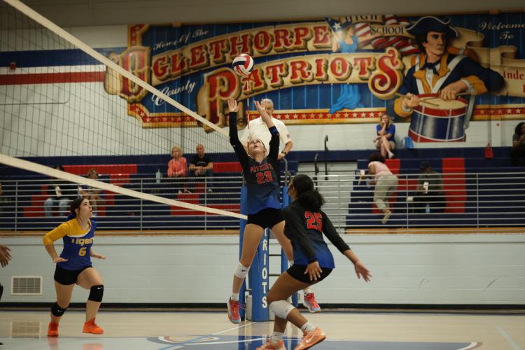 Oglethorpe County’s Naomi McPeake (23) soars to set up teammate Alexis Fleming (25) in the Patriots’ 25-10, 25-3 victories over Washington-Wilkes on Tuesday. The Patriots improved to 8-4. (Photo/Ty Johnston)